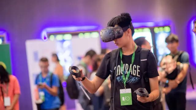 A man wearing a virtual reality headset participates in an event, highlighting the immersive nature of modern technology.